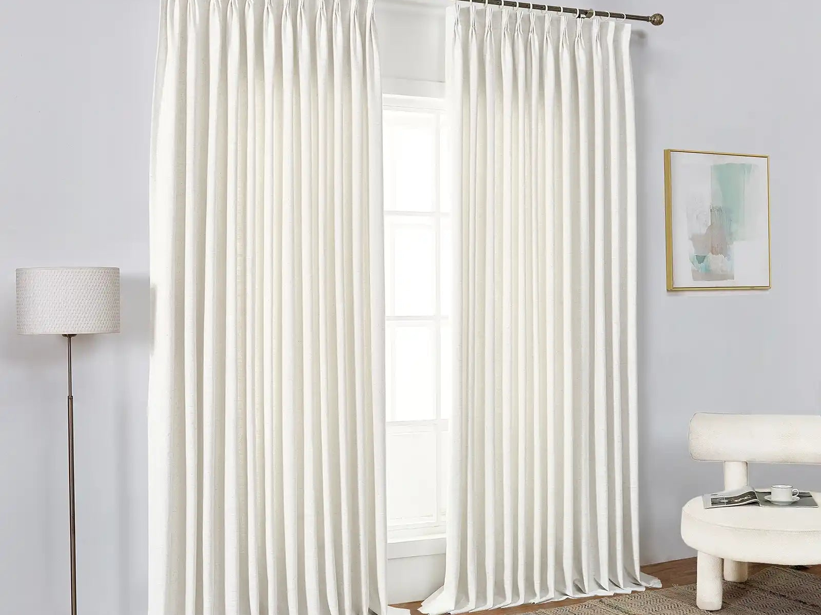White blackout curtains covering a bedroom window for light control
