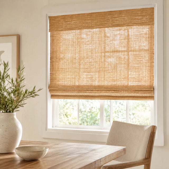Natural woven bamboo shade on a bright window