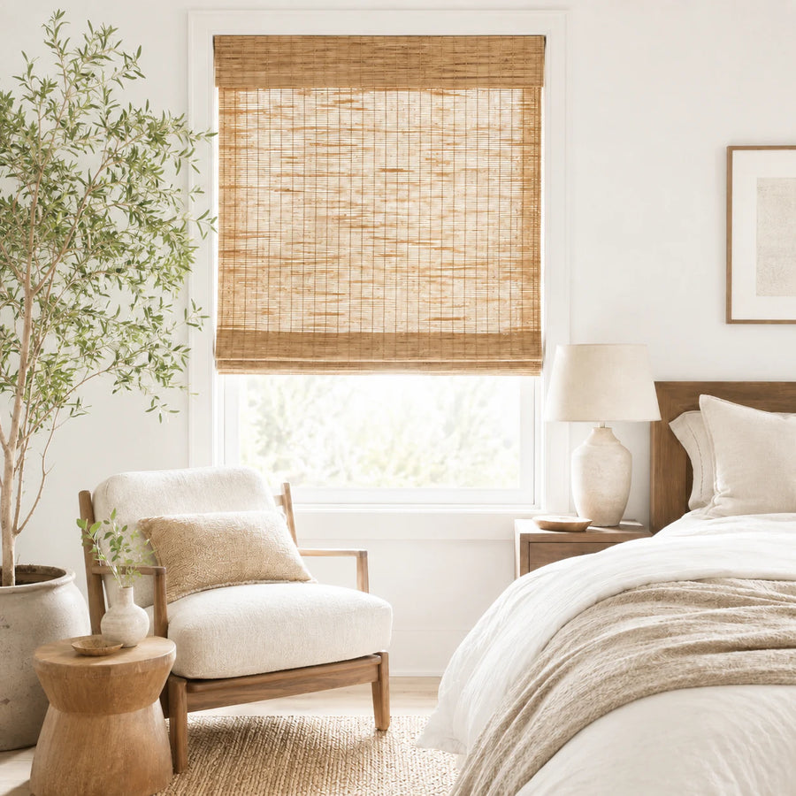 Woven bamboo shade installed in a bright bedroom